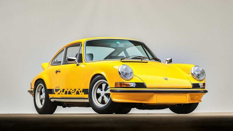 A yellow 1973 Porsche 911 Carrera RS on display