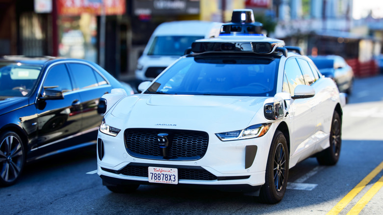 Front view of a Waymo robotaxi driving down street