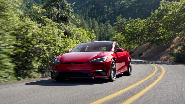 The last Tesla Model S in red on the move, front 3/4 view