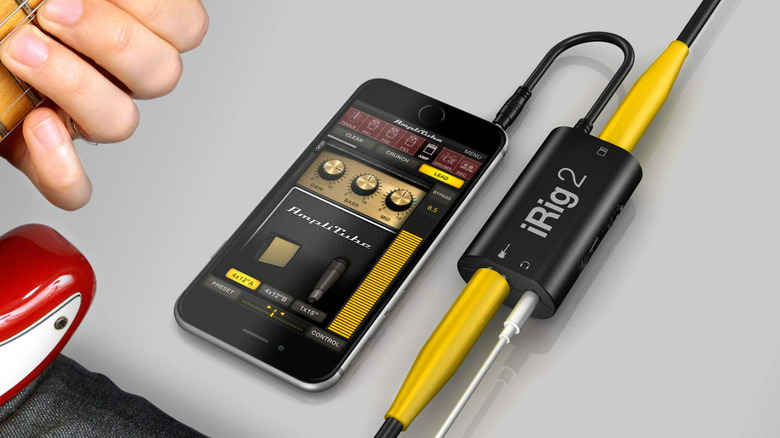 The iRig 2 interface plugged into an iPhone and a guitar.