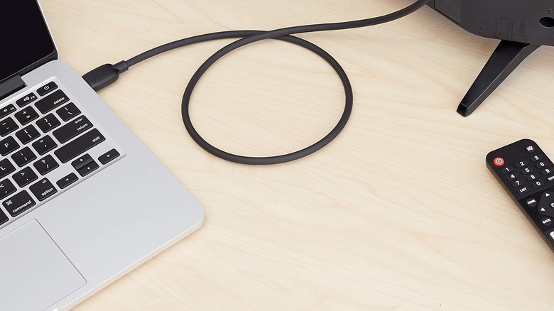 cable connected to a laptop and monitor on a desk