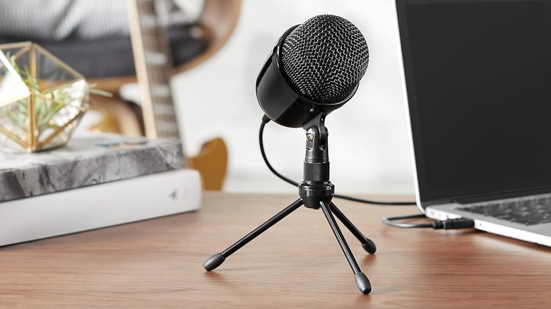 Microphone on a desk with laptop nearby