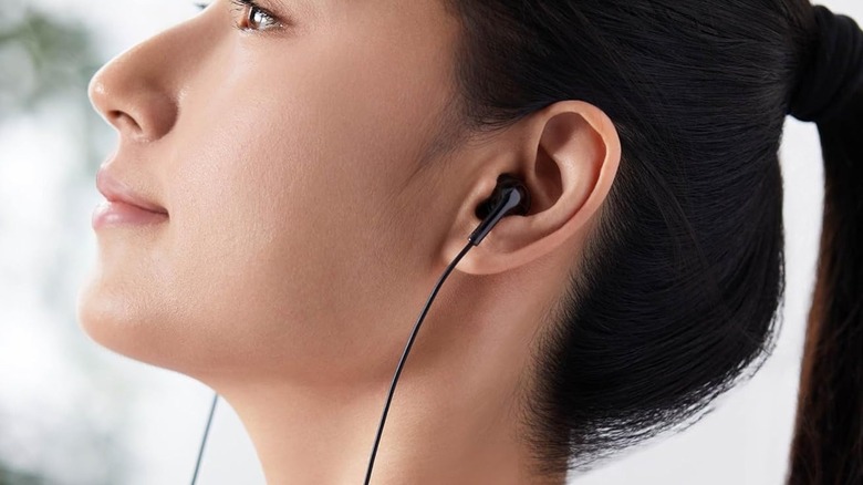 Earbuds in woman's ears