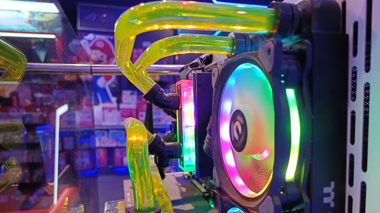 Custom liquid-cooled gaming PC featuring vibrant RGB lighting and Thermaltake components