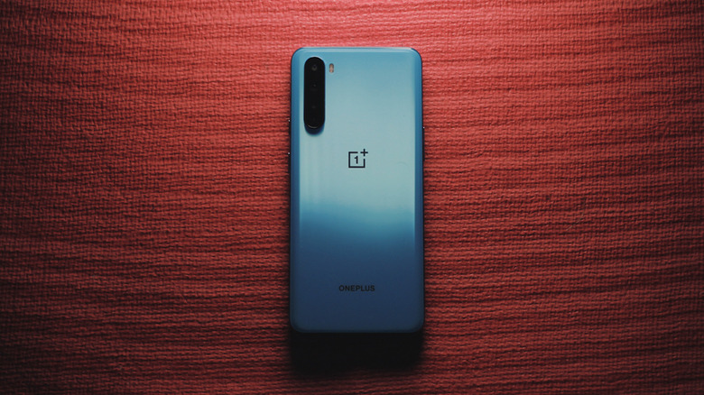 Blue Android phone on a red desk