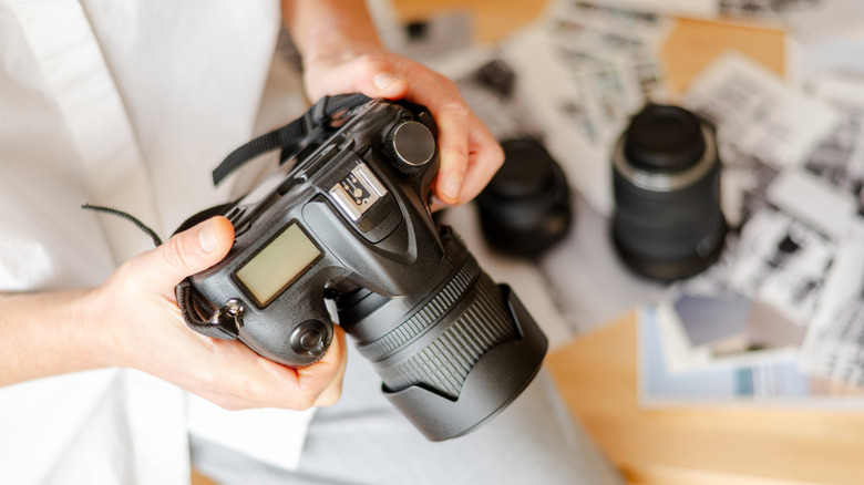A person looking down at the controls on their camera