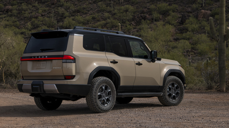 Rear three-quarters view of bronze 2026 Lexus GX parked in the desert