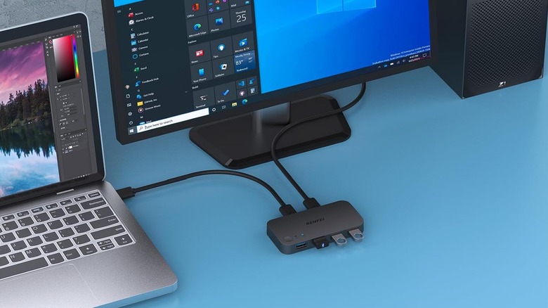A USB switch selector plugged into a desktop and a laptop.