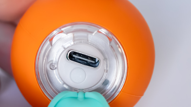 Close-up of an orange gadget with a USB-C port