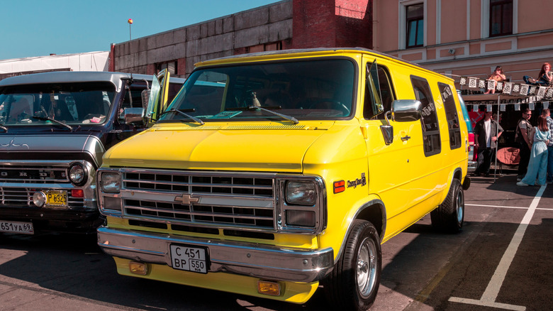1970s yellow chevrolet van in parking lot