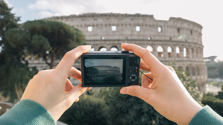 A point and shoot camera directed at the colosseum in Rome
