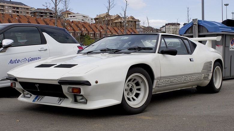 A white De Tomaso Pantera GT5-S parked outside.