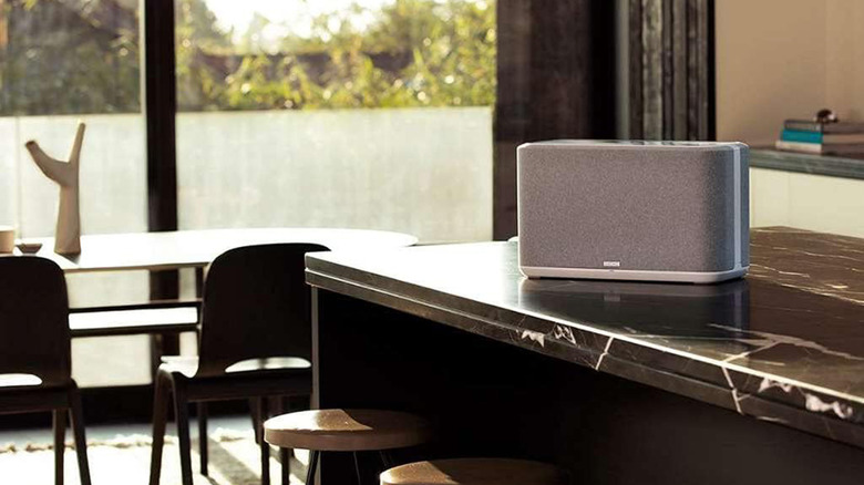 A Denon Home 350 speaker on a table in a kitchen