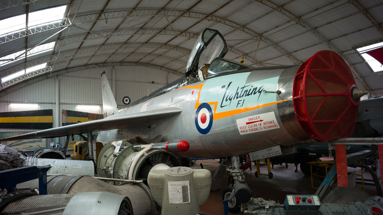 English Electric Lightning jet inside hangar with jet engines
