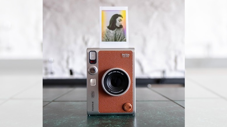 the Fujifilm instax mini Evo on the floor with a printed photo