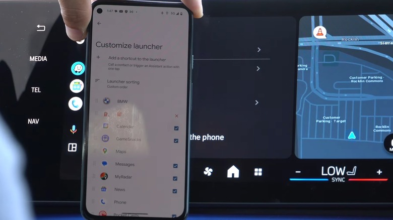 Person showing the Customize Launcher Android Auto settings on his smartphone