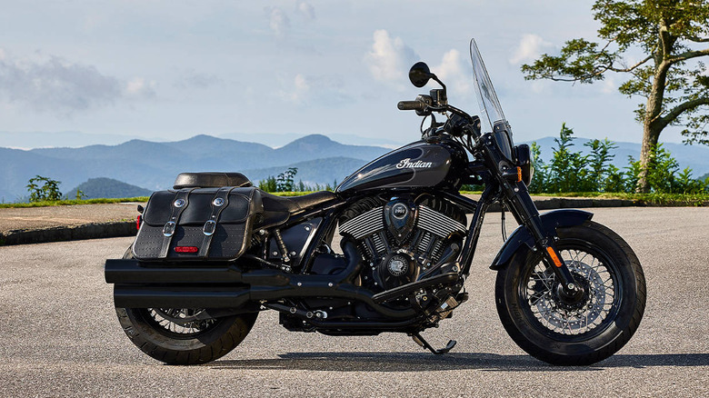 A black Indian Super Chief motorcycle parked on a deserted stretch of road.