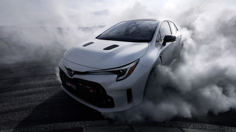 Toyota GR Corolla drifting with a lot of smoke front 3/4 view