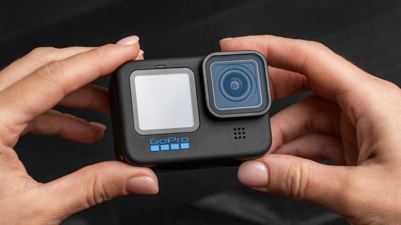 A person holding a GoPro camera