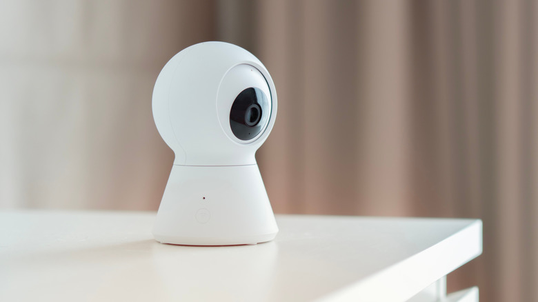 A smart home camera on a white table
