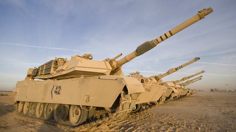 A row of tanks with turrets raised, each displaying the 