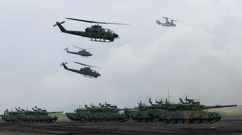 Helicopters and tanks operating in formation