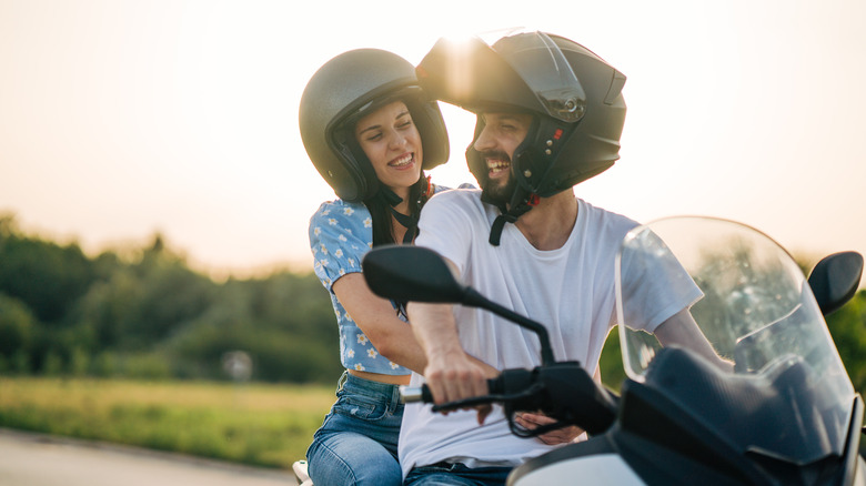 Young couple riding on motorcycle