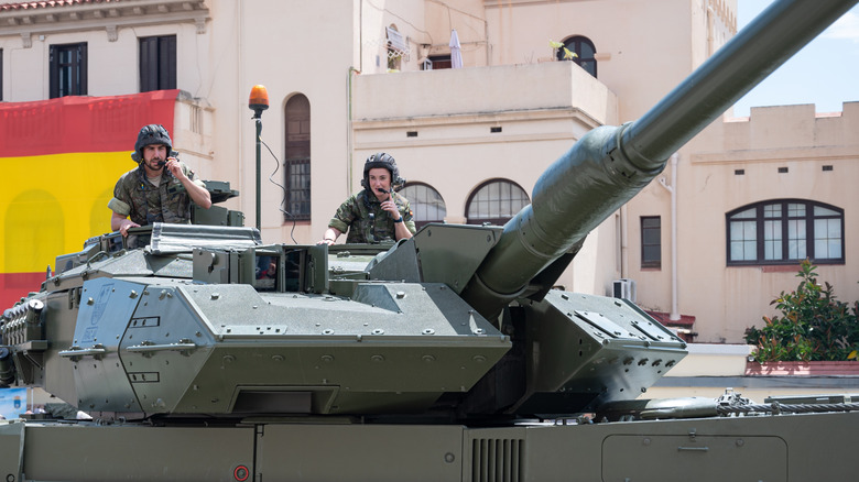 Two soldiers looking out of a tank turret