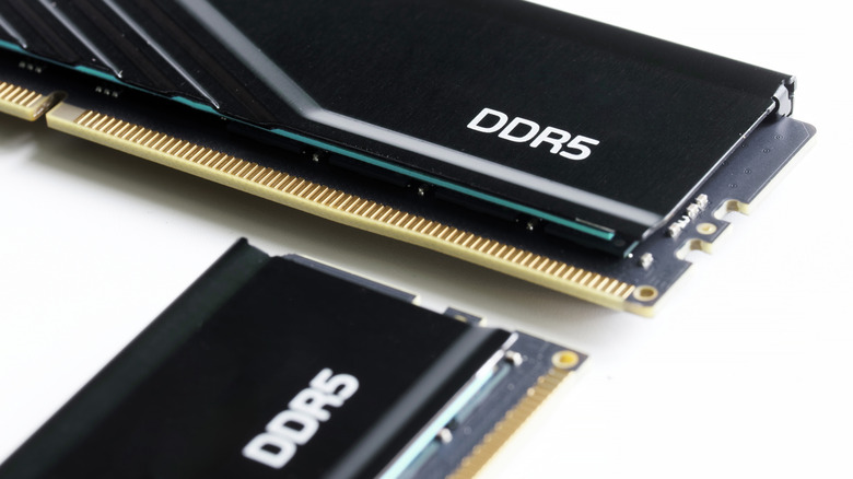 Two DDR5 RAM sticks on a white surface.