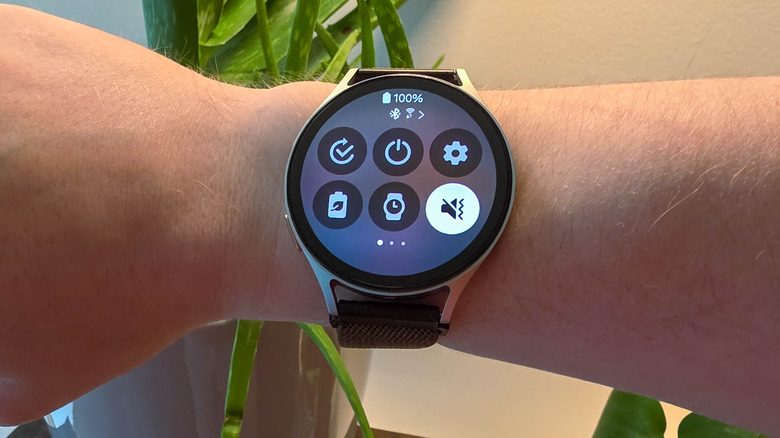 Samsung Galaxy Watch7 on a person's wrist showing quick settings icons