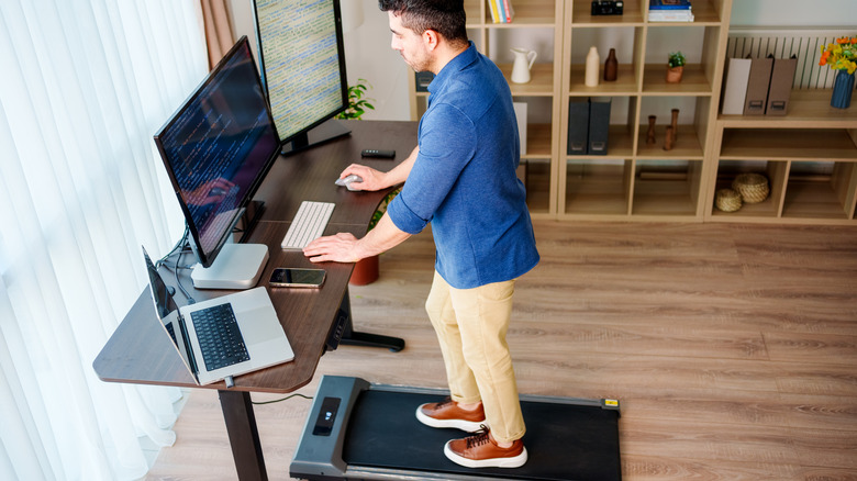 Man using walking pad while working