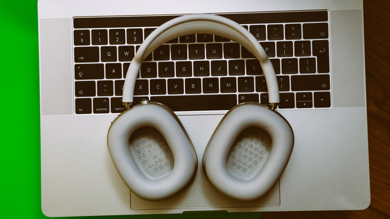 Apple AirPods Max placed above a MacBook Pro.