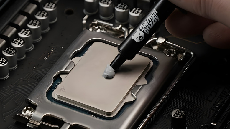 PC builder applying Thermal Grizzly Kryonaut thermal paste to a CPU