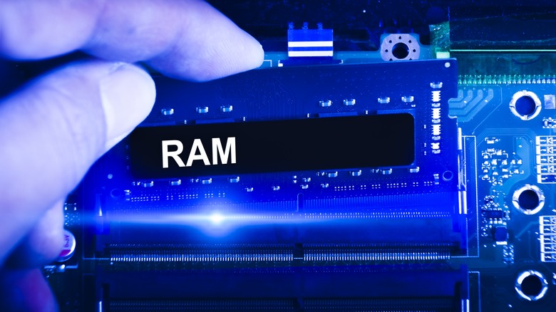A person installing a RAM to the motherboard