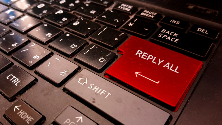 A red reply all button stands out on a black keyboard