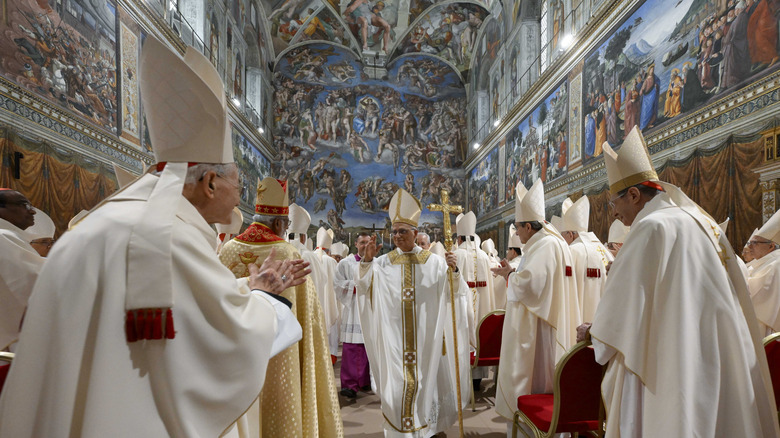 Pope leading mass inside Sistine Chapel.