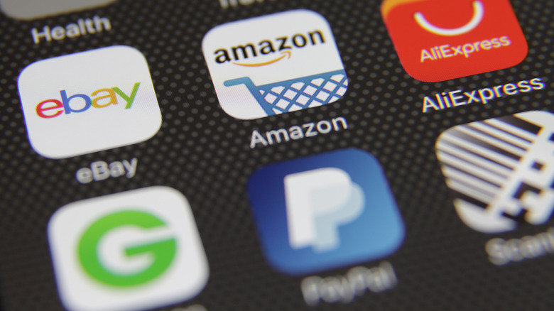 Phone screen showing the Amazon app above a slightly out of focus PayPal app icon