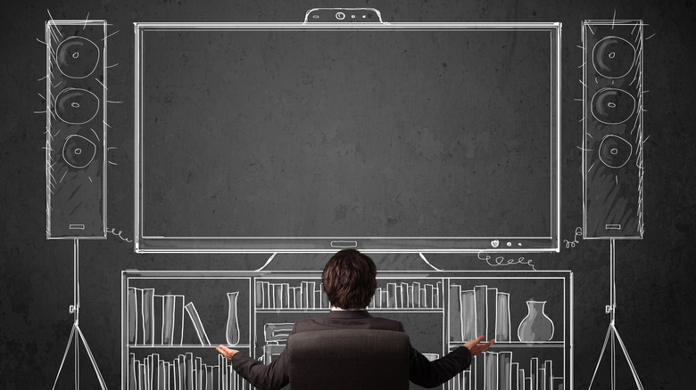 Person sitting in front of animated home theater system