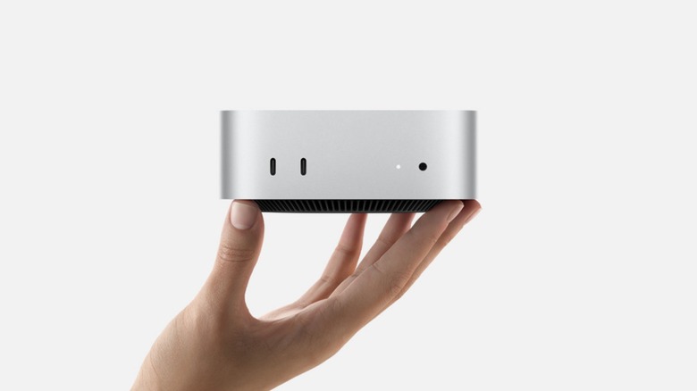 Person holding mac mini