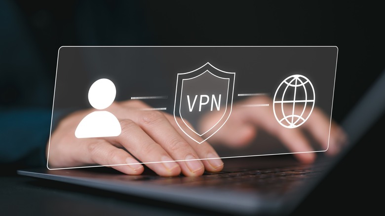 Feminine hands on a laptop with a virtual screen showing a VPN shield as the middle man between users and the internet