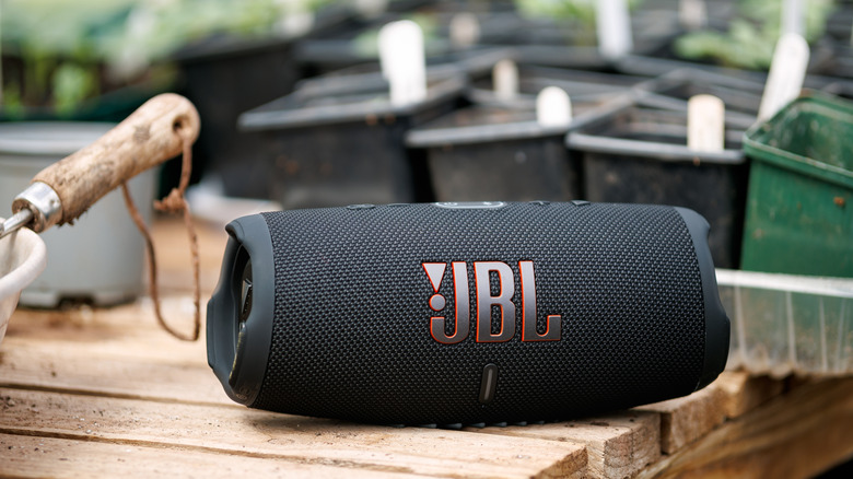 JBL portable Bluetooth speaker on a wooden table.