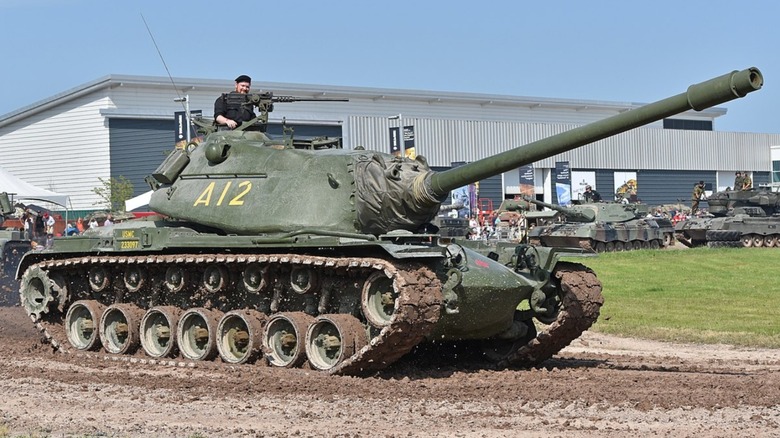 An M103A2 tank being driven at a tank show