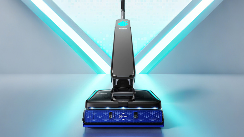 Man vacuuming floor with Tineco product