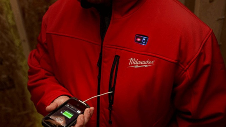 A person wearing a Milwaukee heated jacket.