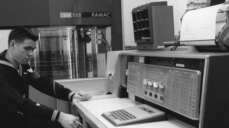 A black and white image of a RAMAC 305, with a RAMAC 350 HDD in the background