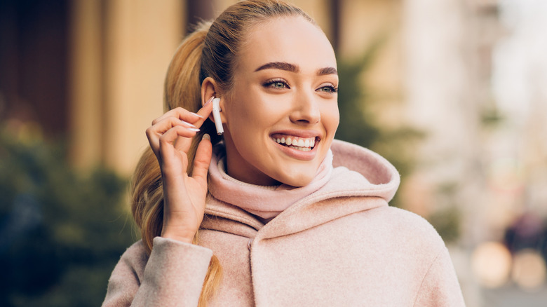 woman using AirPods