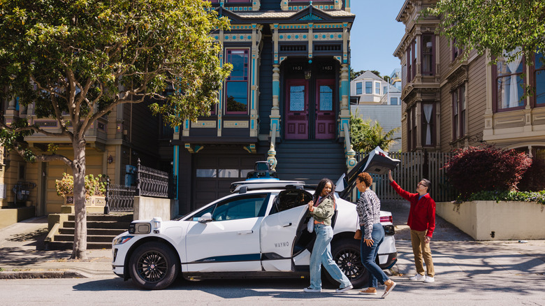 Three people using Waymo in San Franicsco, California
