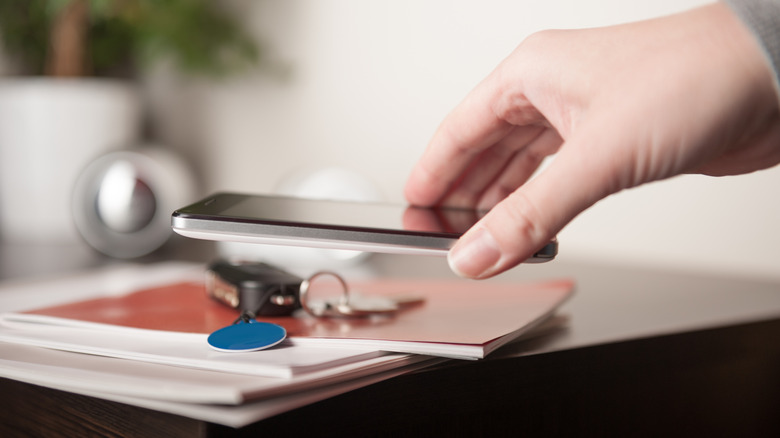 Smartphone scanning a blue NFC tag