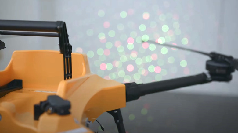 BB102 drone projecting laser lights on a wall