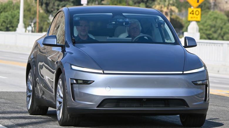 Silver Model Y driving down the road